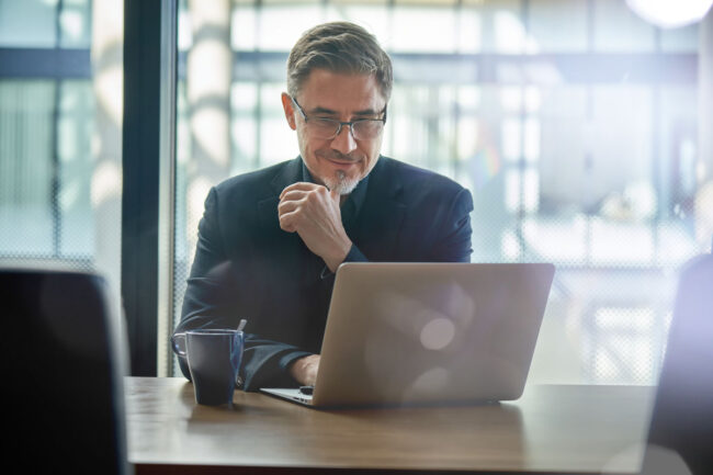 businessman working on laptop in the commercial insurance industry