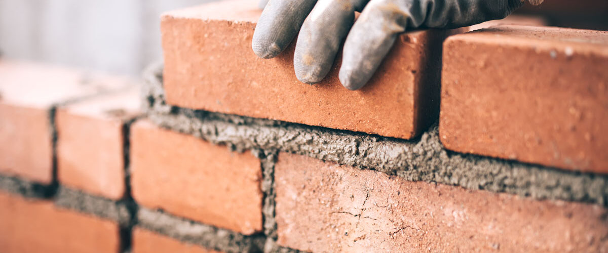 Close up of industrial bricklayer for tradesperson insurance