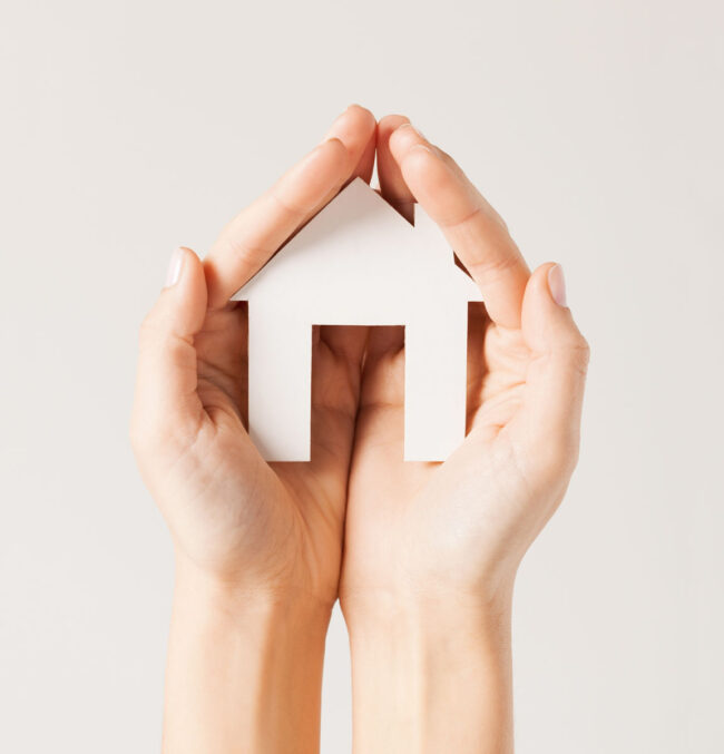 Hands holding a home for property insurance